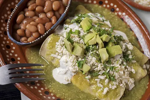 Green Enchiladas with Pork accompanied with pot beans